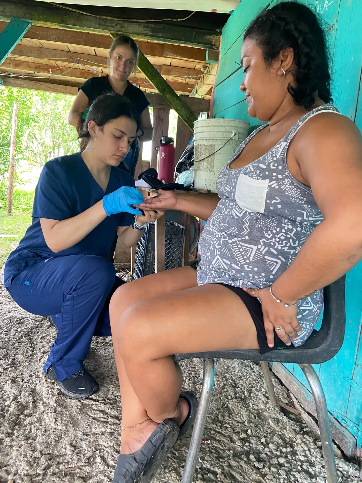 Nursing student taking a patient's pulse in Belize