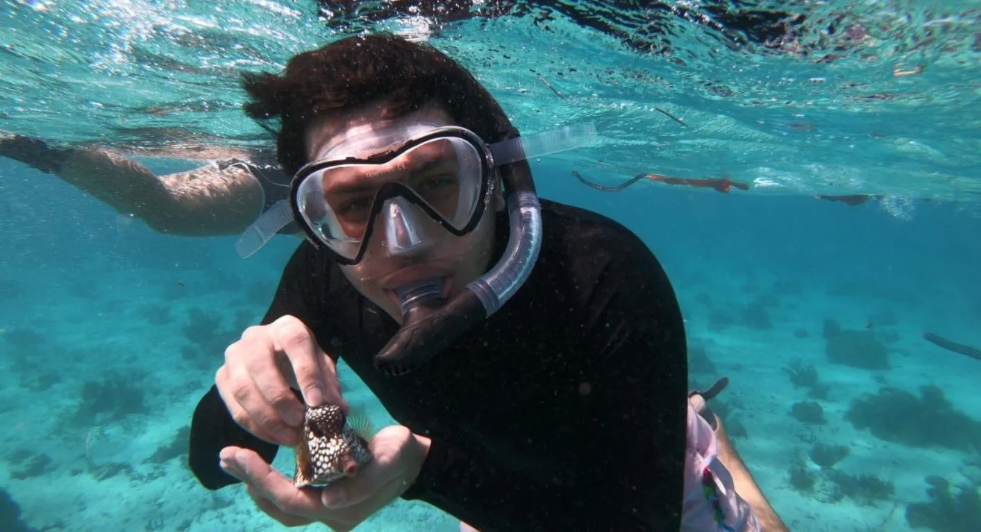 Student snorkeling on a reef in Belize