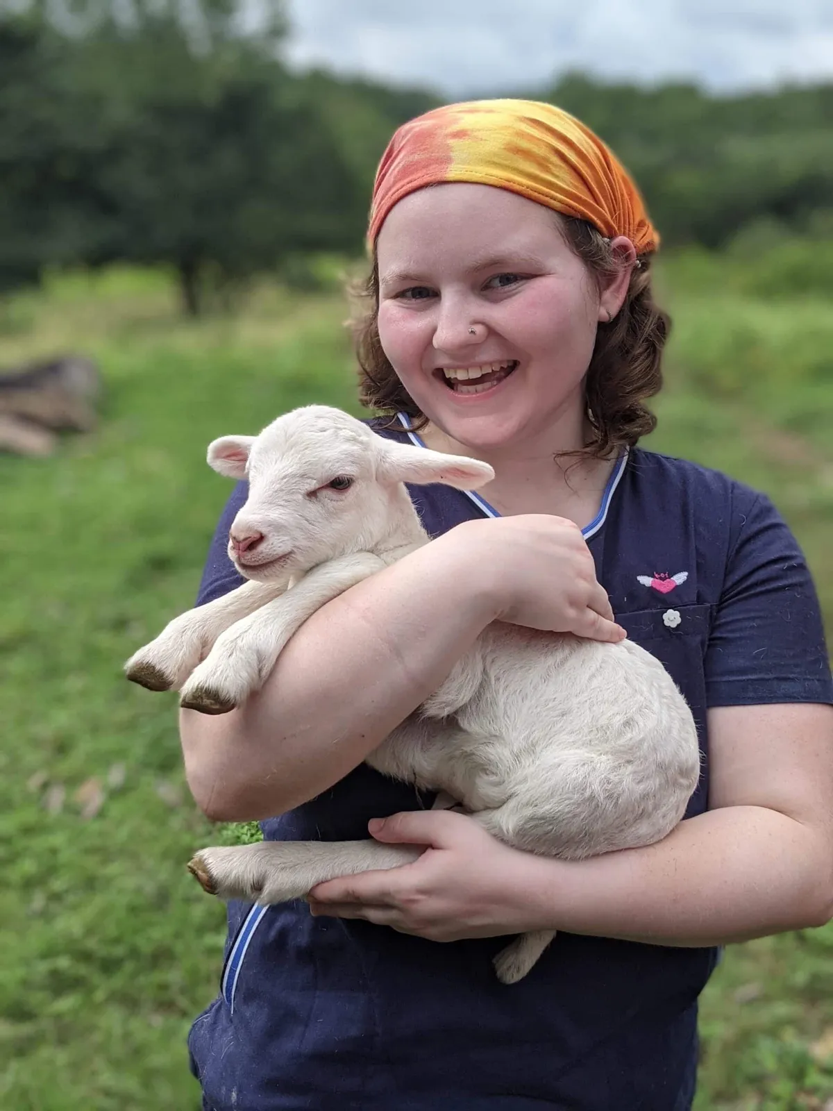 Animal science student holding a lamb in Belize