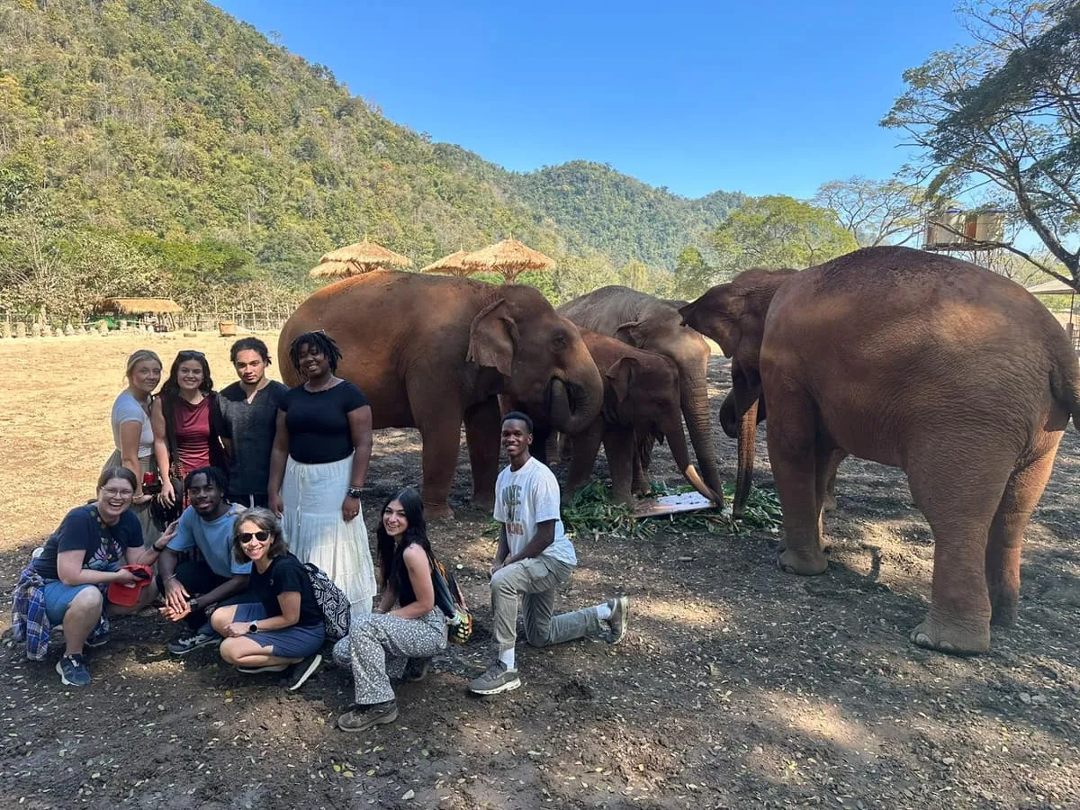 Group of students with elephants at Elephant Nature Park