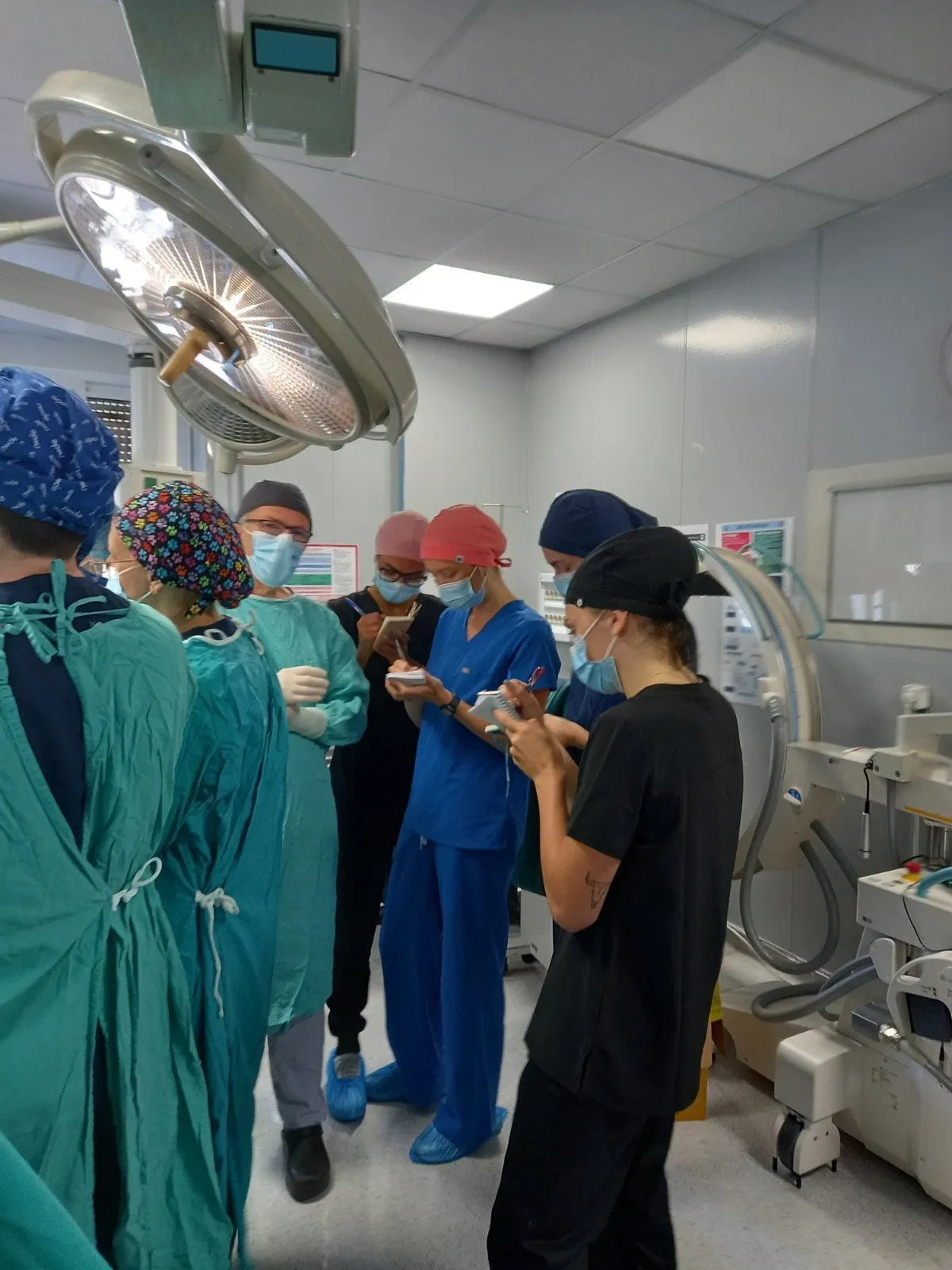 Students in scrubs observing in an operating room at Metropolitan General Hospital