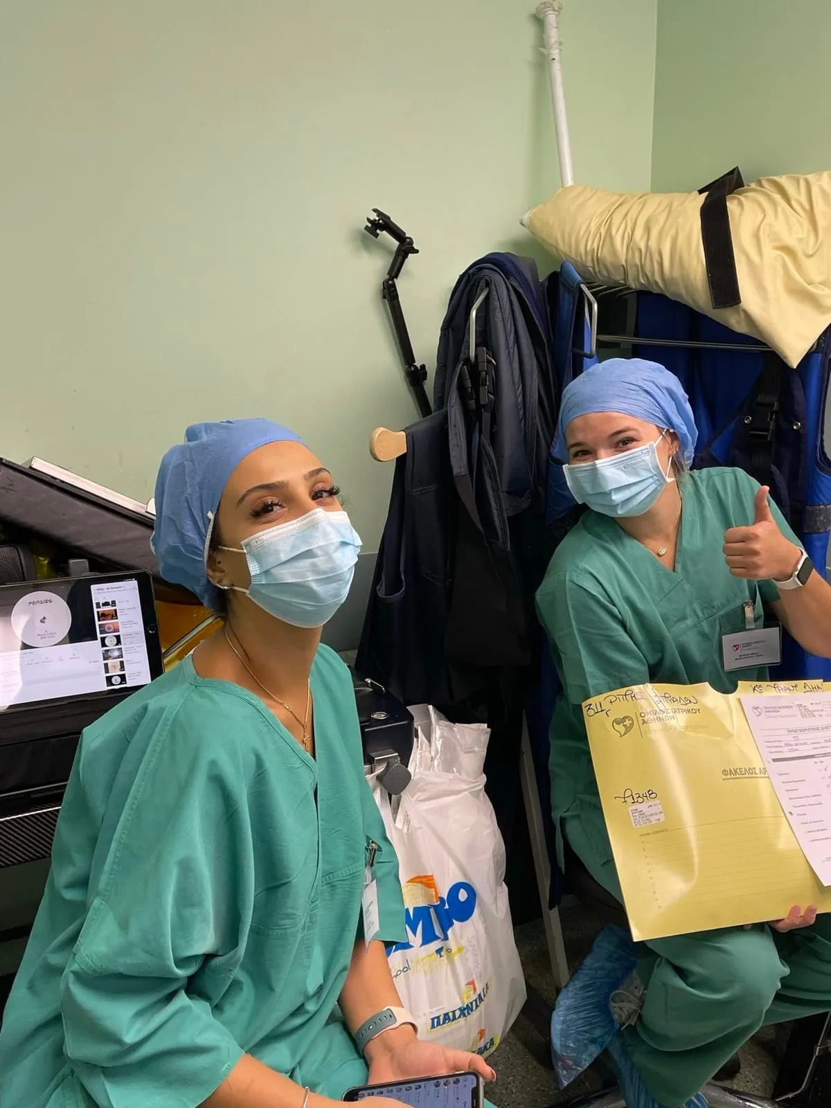 Two students in scrubs and surgical caps at the hospital