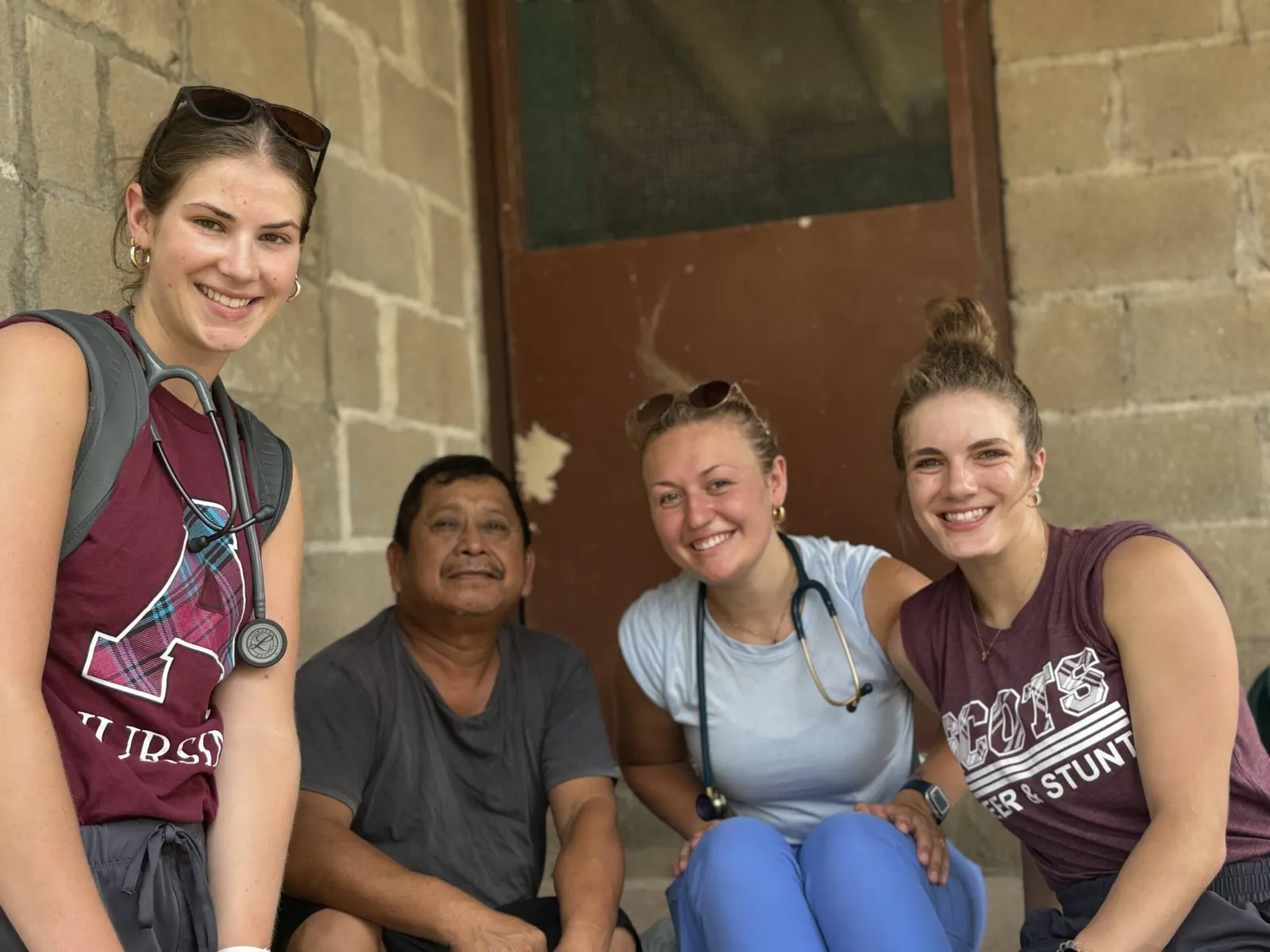 Students sharing a cultural experience with a local community member in Belize